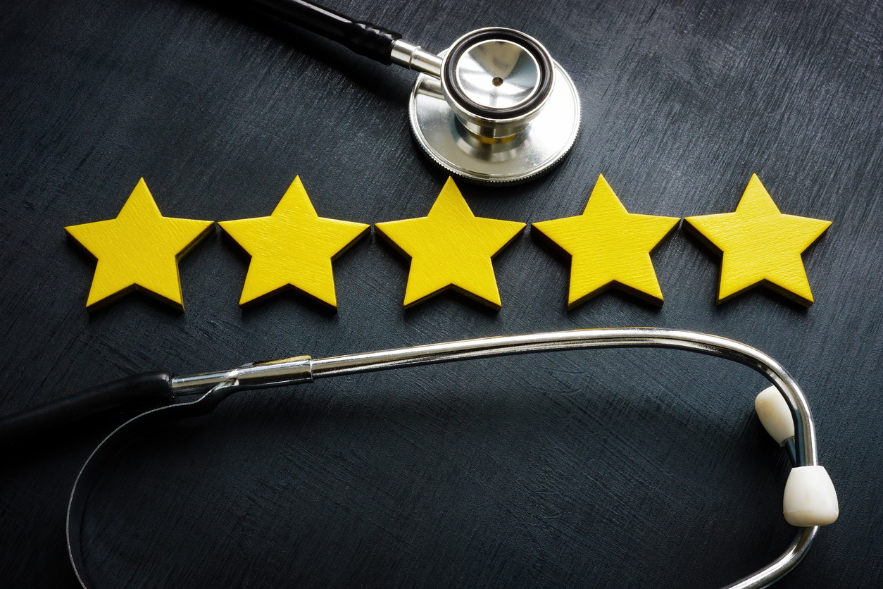 Five yellow stars and stethoscope as concept of patient satisfaction.