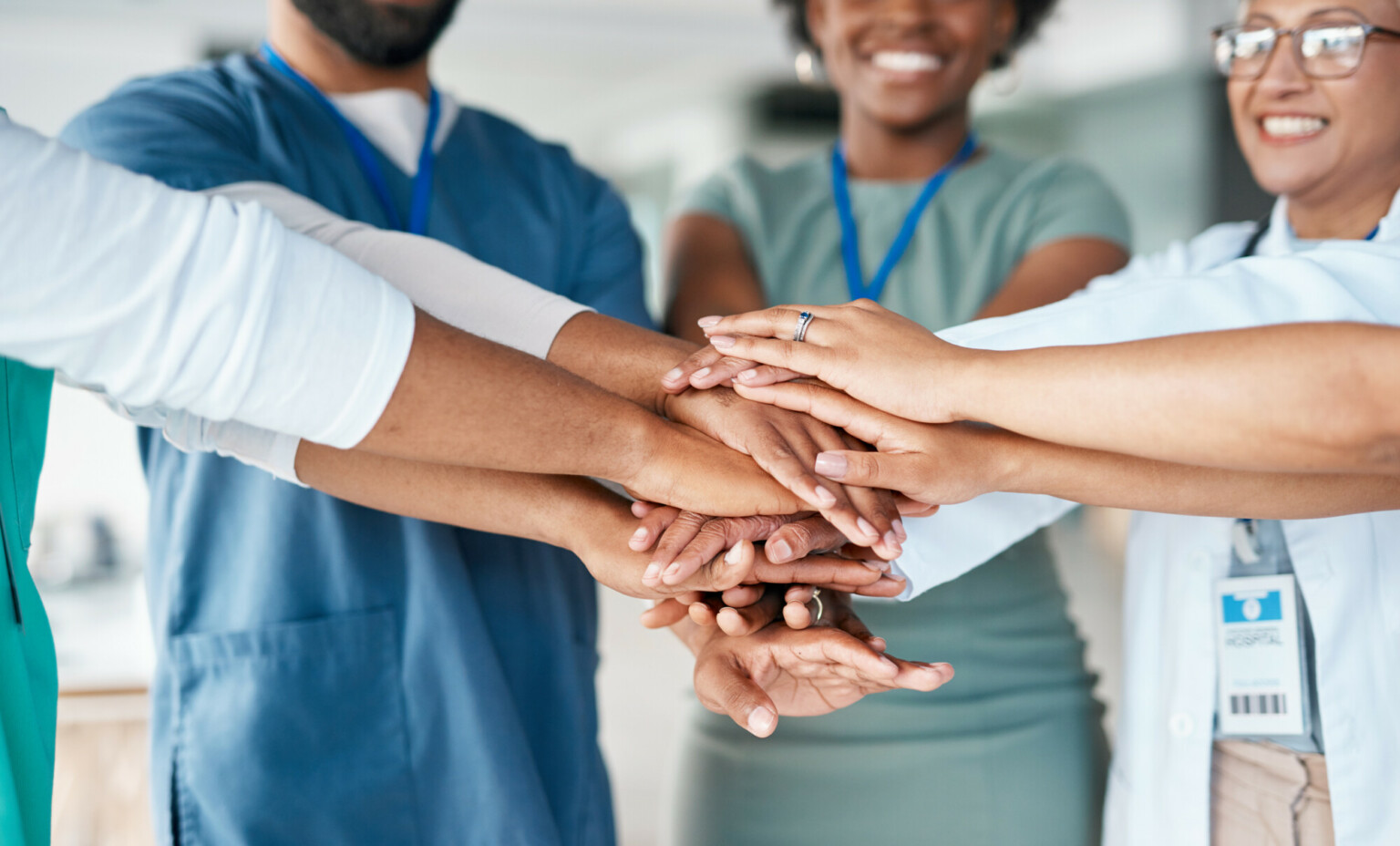 Hands together of doctors and nurses in healthcare teamwork, solidarity and support in hospital diversity. Workflow of medical people, staff or employees in hand stack sign for happy clinic workforce